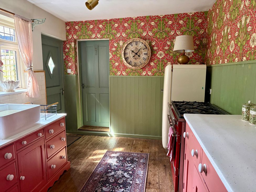 A kitchen with a sink and stove at Liberty House in Ashbourne