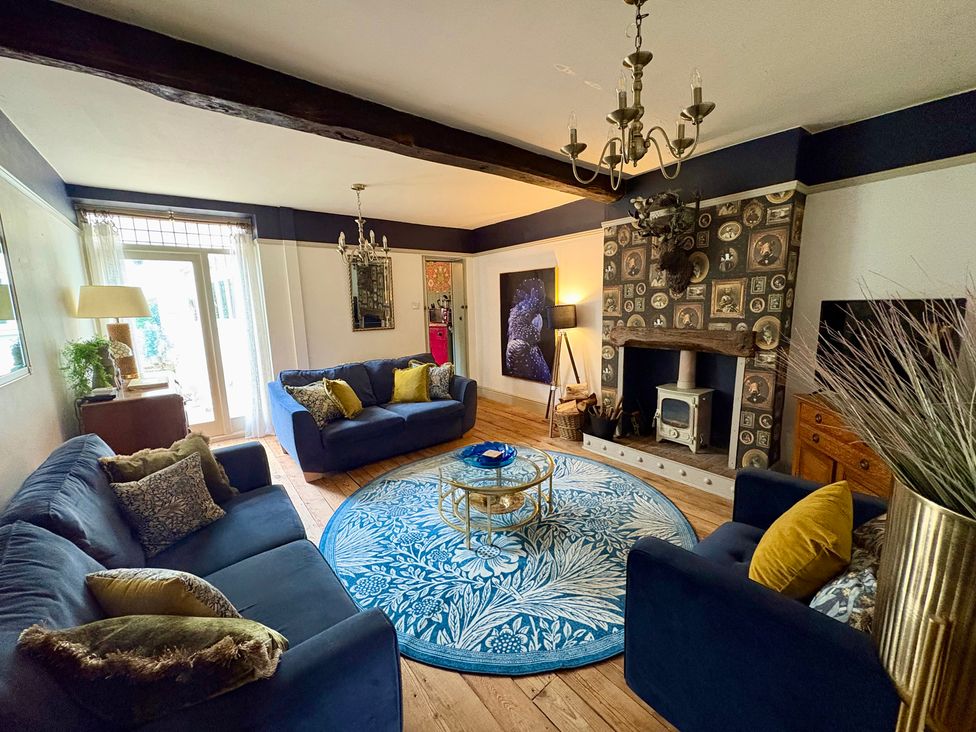 A living room with sofas and a fireplace at Liberty House in Ashbourne