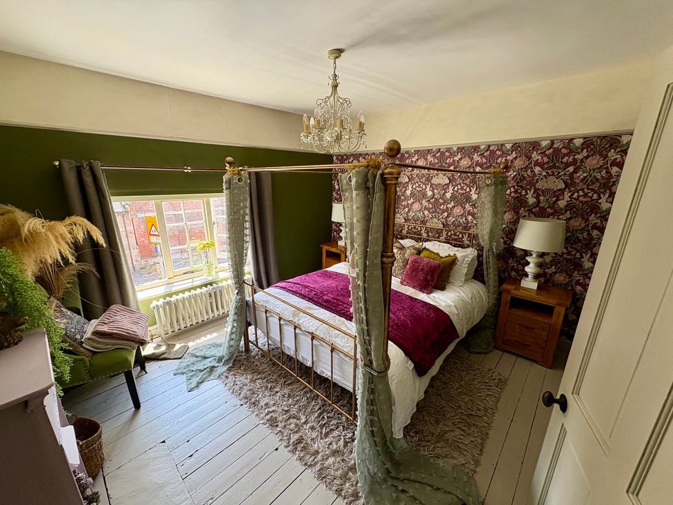 A bedroom with a bed and a chair at Liberty House in Ashbourne