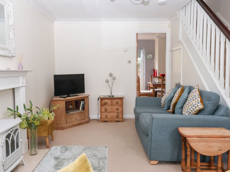 A living room with a sofa and television at 17 Fewster Way in York