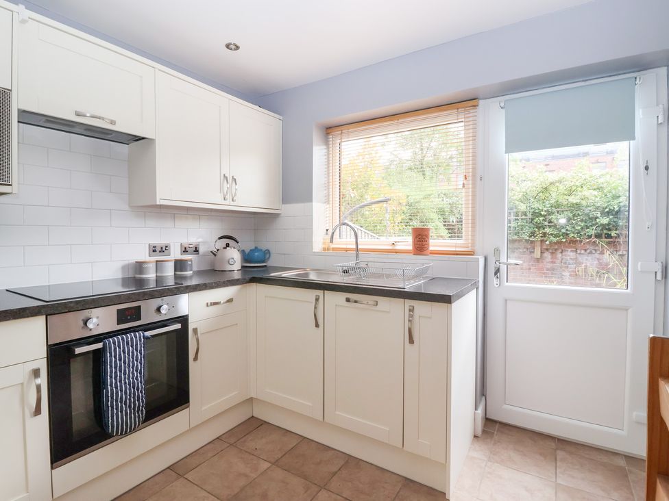 A kitchen with cabinets, sink, and oven at 17 Fewster Way, York