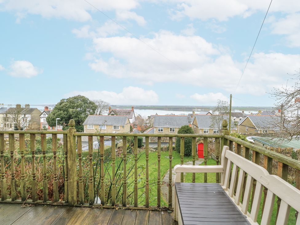 A garden with a view of houses and greenery at Preswylfa Apartment in Caernarfon
