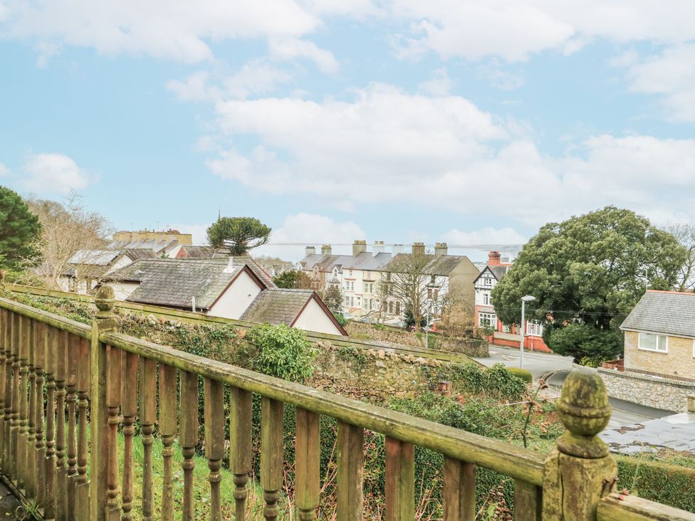 A view of houses and trees from a fence at Preswylfa Apartment Caernarfon