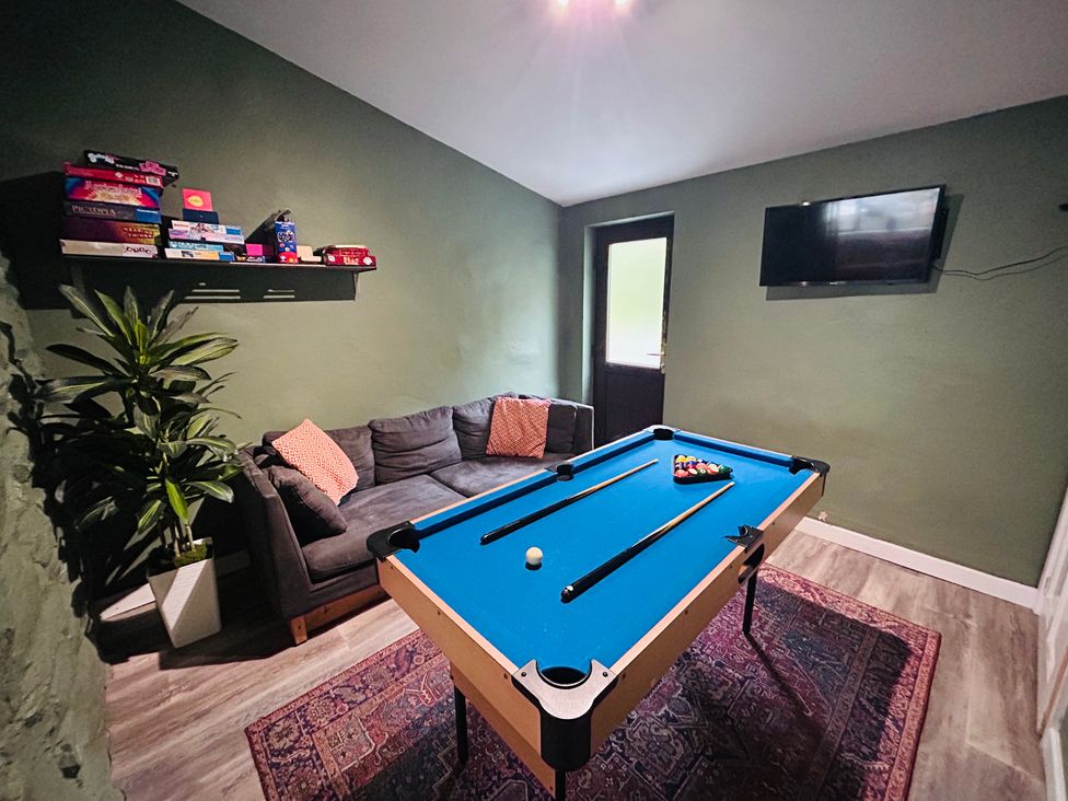 A game room with a pool table and a sofa at Stiniog Lodge in Blaenau Ffestiniog