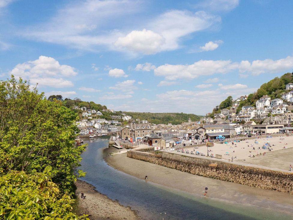 A view of a beach and river with houses near Pelynt near Looe