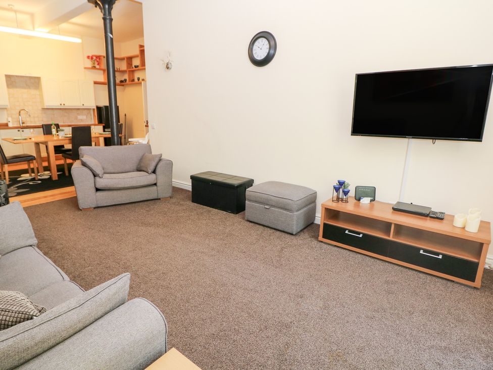 A living room with a sofa and television at Wye Apartment, Litton Mill in Litton Mill