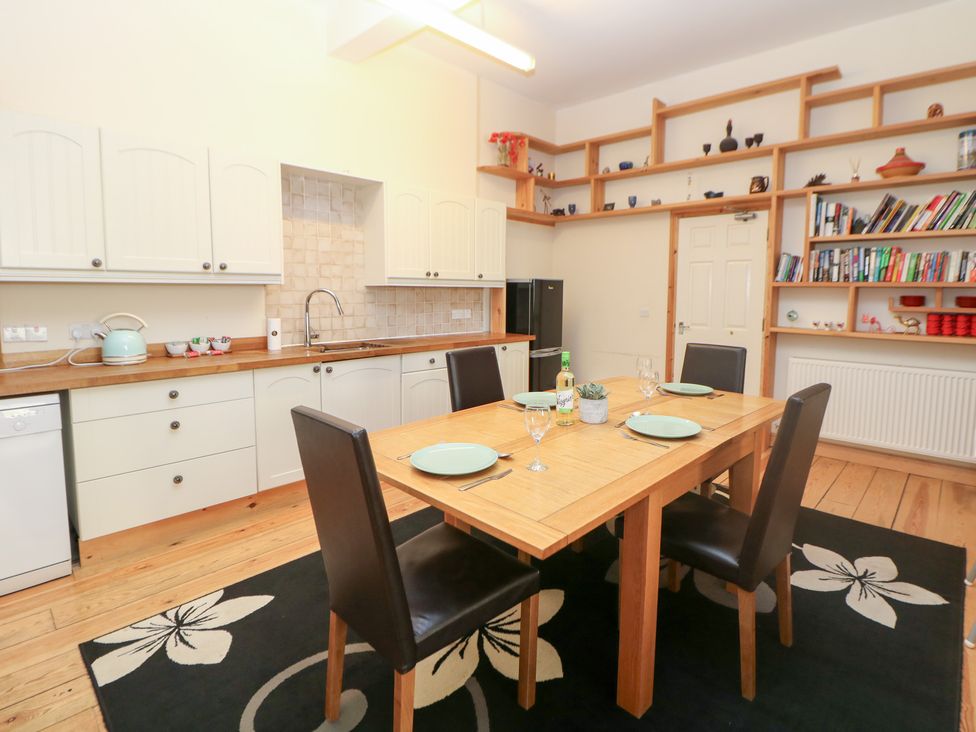 A kitchen with a dining table and chairs at Wye Apartment, Litton Mill in Litton Mill In Miller's Dale