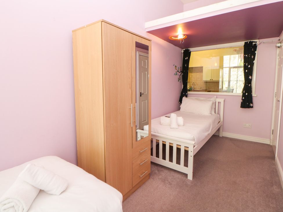 A bedroom with a bed and wardrobe at Wye Apartment, Litton Mill in Litton Mill In Miller's Dale