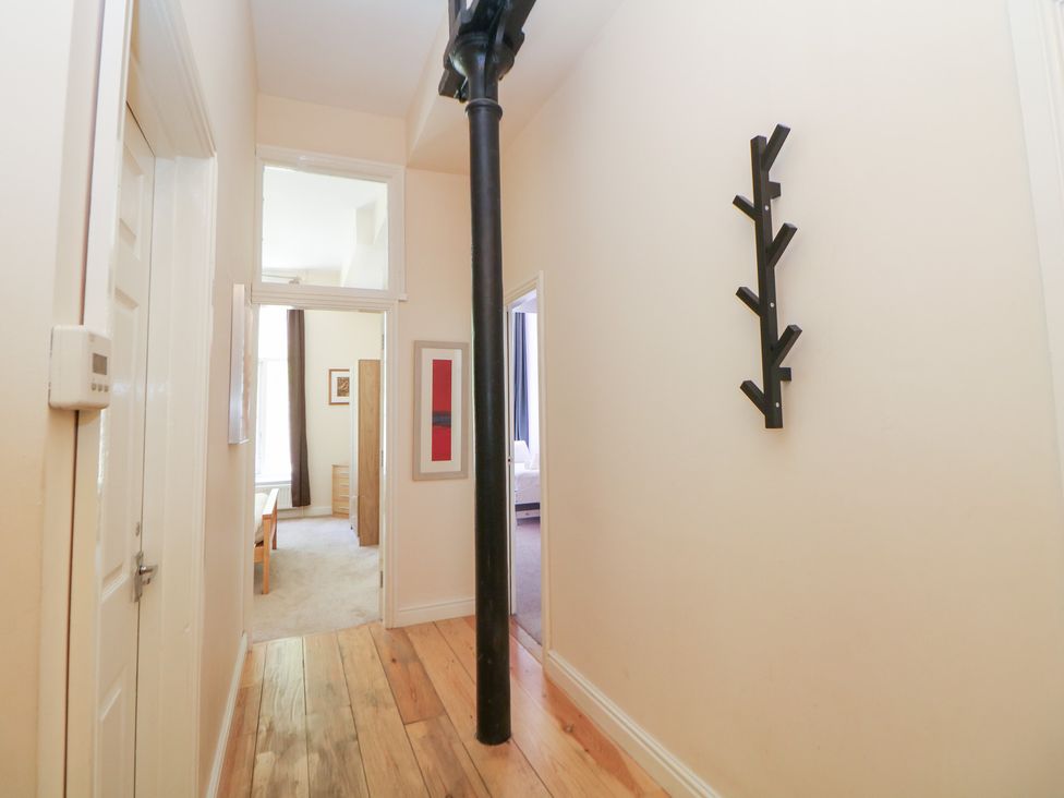 A hallway with wooden flooring and a coat rack at Wye Apartment, Litton Mill in Litton Mill