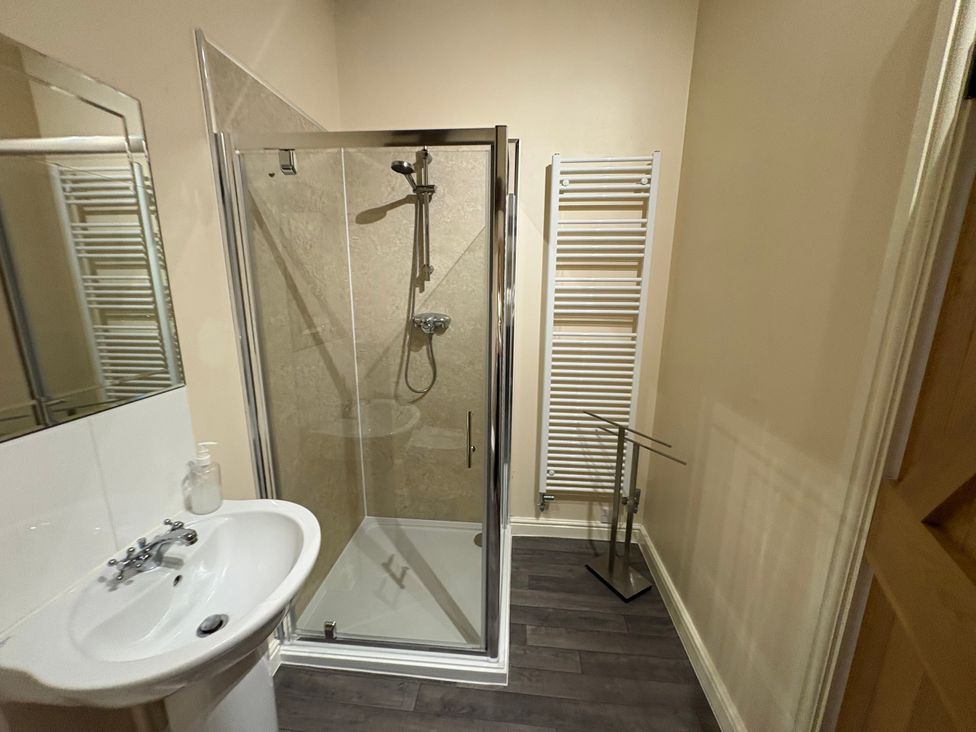 A bathroom featuring a shower and washbasin at The Joiners Shop in Melbourne, Derbyshire