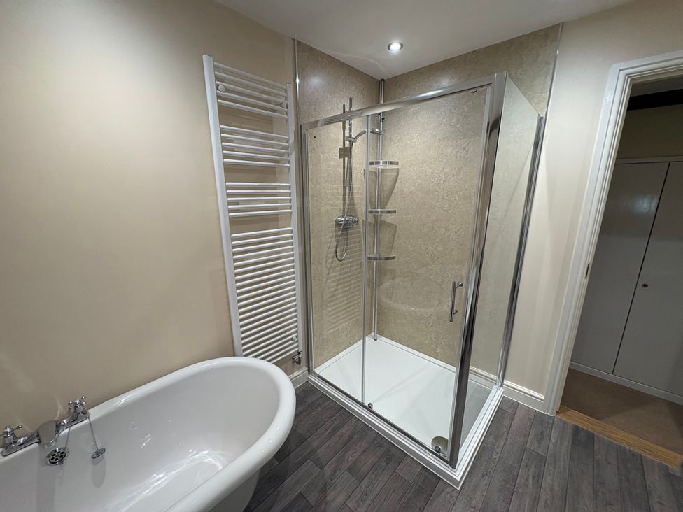 A bathroom with a bathtub and shower at The Joiners Shop in Melbourne, Derbyshire