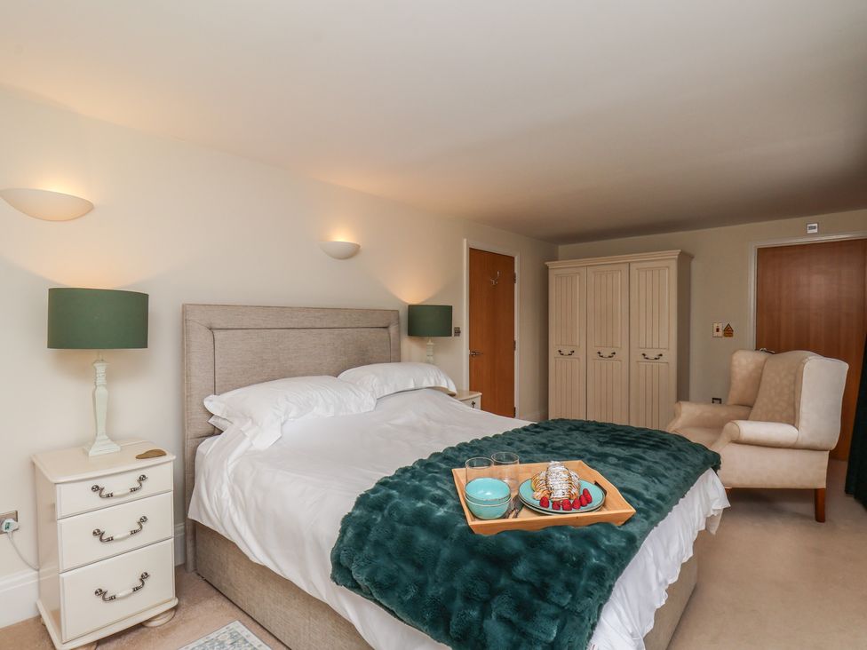 A bedroom with a bed and bedside table at 5 Old Sail Loft in Whitby