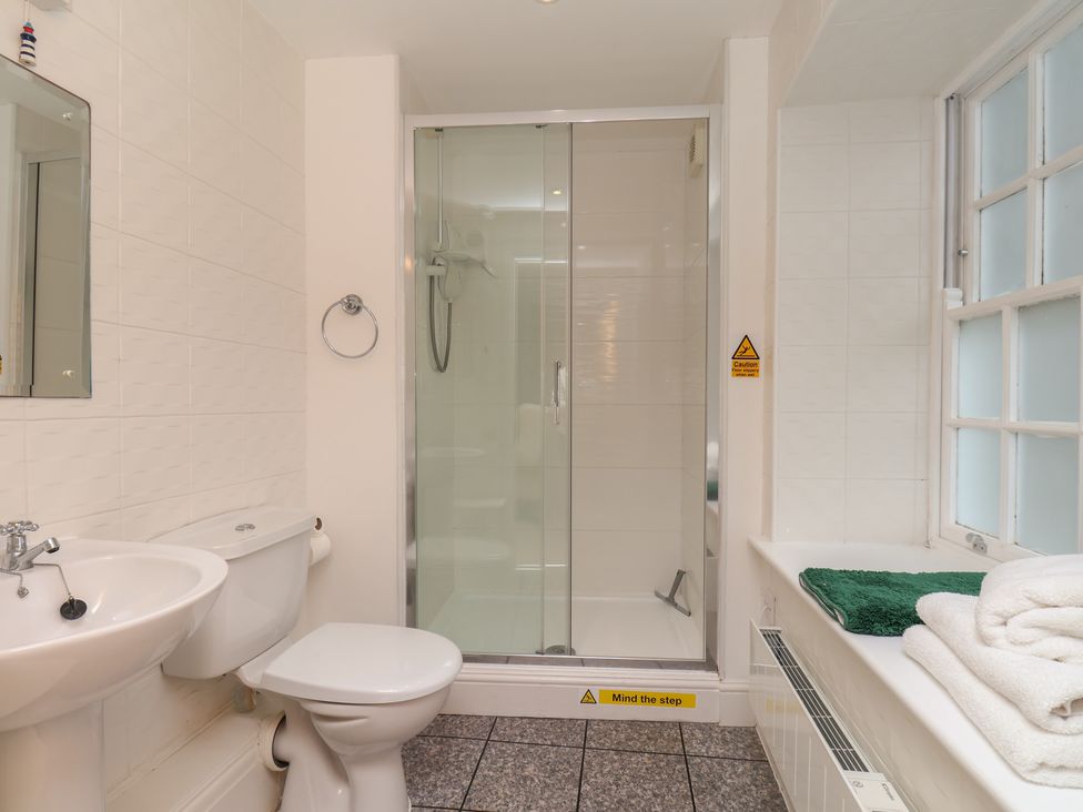 A bathroom with a shower and sink at 5 Old Sail Loft in Whitby