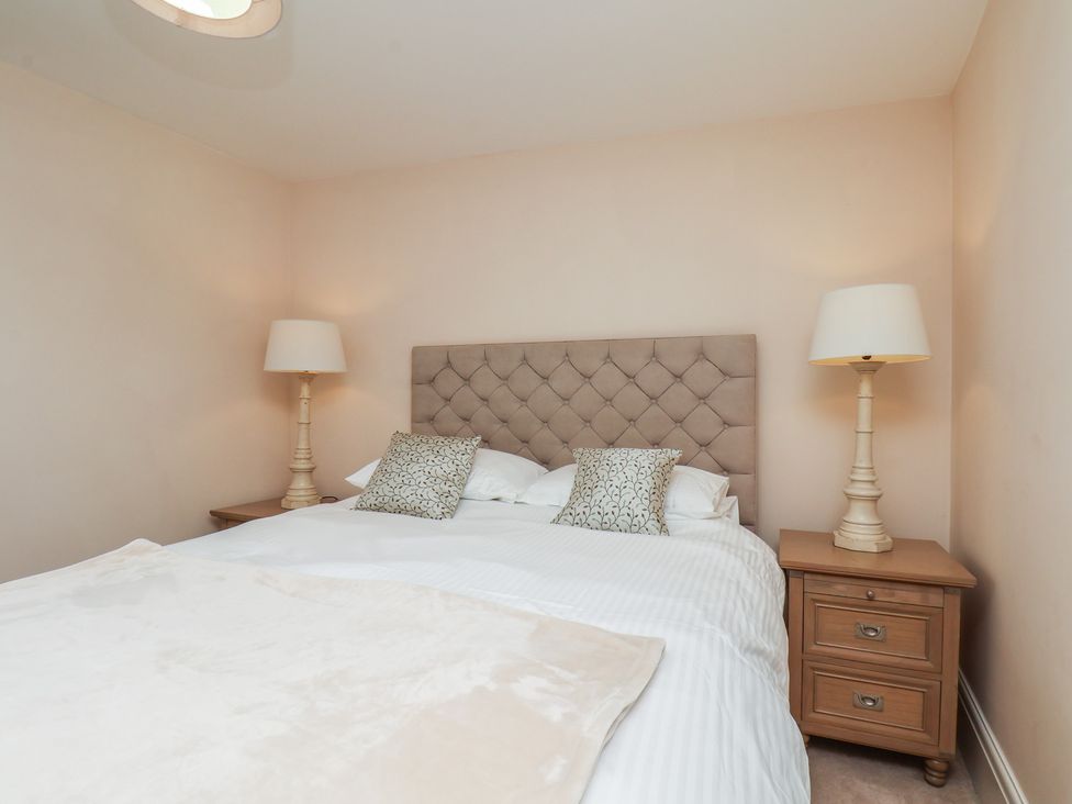 A bedroom with a bed and bedside tables at 5 Old Sail Loft in Whitby